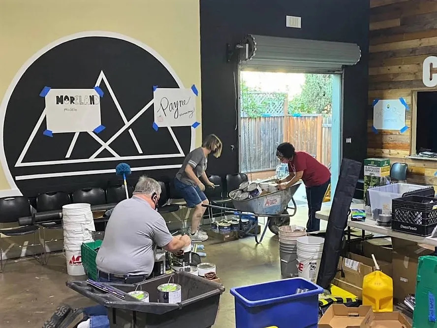 three people on the Materials Distribution Team organizing supplies at a warehouse